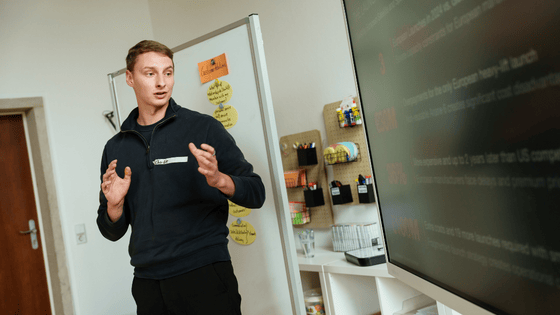a photo of a male person looking into a screen and presenting 