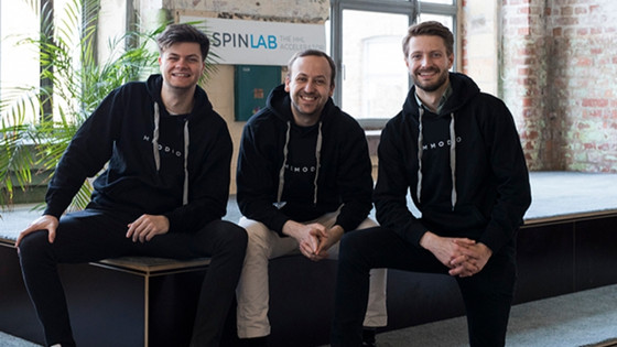 A photo of the memodio founding team, 3 men sitting and wearing black hoodies