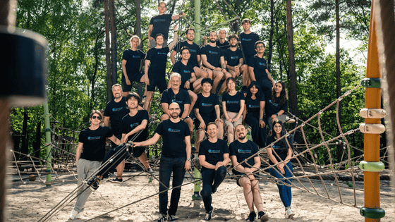A photo of the team of SpinnCloud, sitting and all wearing the same SpinnCloud branded black shirt
