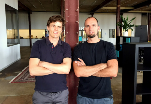 a photo of the founders of rhebo, two males in a black shirt looking into the camera.