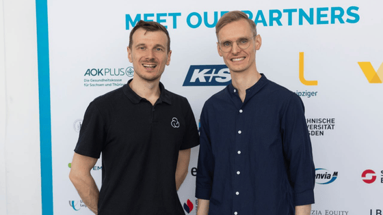 A photo of Eric Weber (left) and Johannes Ullrich (right) standing next to each other, smiling and looking directly to the camera. 